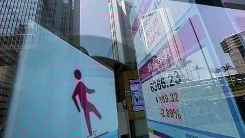 An electronic screen displays the Hang Seng Index, top, and Hang Seng China Enterprises Index (HSCEI) in Hong Kong, China, on Tuesday, March 15, 2022. Chinese stocks suffered another deep selloff on Tuesday as concerns about the countrys ties with Russia and persistent regulatory pressure sent shares on a downward spiral. Photographer: Paul Yeung/Bloomberg