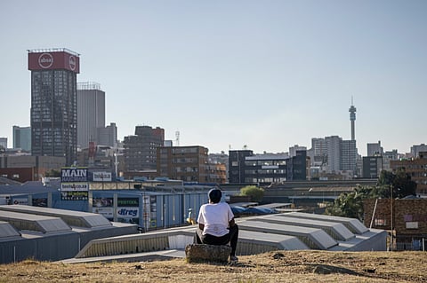 A resident looks out towards the skyline of the central business district in Johannesburg, South Africa, on Tuesday, Aug. 15, 2023. The summit of BRICS leaders is scheduled to take place from Aug. 22-24 in Johannesburg, where theyll discuss whether to admit more nations to its ranks.