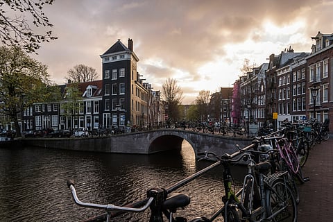 Bicycles rest on bridge railings beside Prince's Canal in Amsterdam, Netherlands, on Monday, March 25, 2019. Amsterdam is the latest European city to try to get a grip on its buy-to-let housing market as it seeks to stop a wave of landlords from capitalizing on booming property prices. Photographer: Geert Vanden Wijngaert/Bloomberg