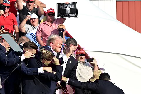 Donald Trump is surrounded by Secret Service agents during a campaign event at Butler Farm Show Inc. in Butler, Pennsylvania, US, on July 13.