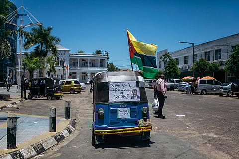 A tuktuk with a political poster and an upside down Mozambican flag in Maputo, Mozambique, on Friday, Nov. 29, 2024. The continued disruption following election results disputes is hitting the already strained state finances with annual inflation in Mozambique edged up to 2.7% in October. Photographer: Kang-Chun Cheng/Bloomberg