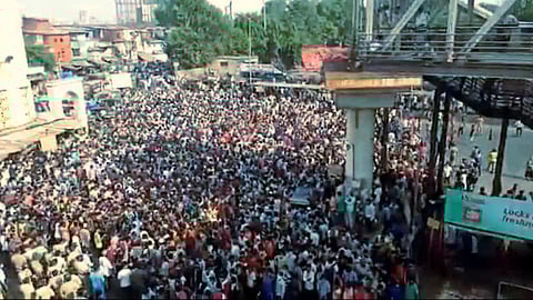 Migrants gather at a protest outside a station in suburban Mumbai during the lockdown