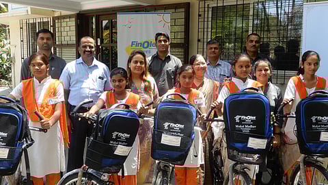 Ritu Chhabria (centre) giving bicycles to girl students