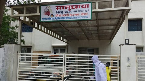 An Amway worker sanitises NGO-run schools