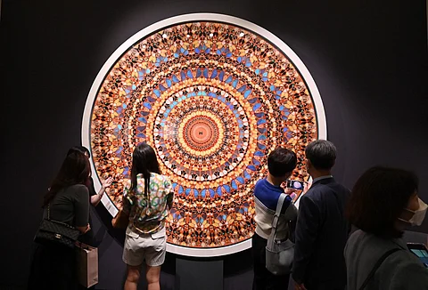 Visitors look at artwork "High Windows (Happy Life), 2006" by artist Damien Hirst during the Frieze Seoul 2022 art fair in Seoul on September 2, 2022. - The art world landed in Seoul this week for the inaugural edition of Frieze in Asia, as the vibrant South Korean capital looks to position itself as the region's next art hub. Photo by Jung Yeon-je / AFP