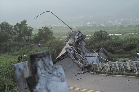 Journalists gather beside the collapsed Kaoliao bridge in eastern Taiwan's Hualien county on 19 September 2022, following a 6.9 magnitude earthquake on September 18. Photo by Sam Yeh / AFP