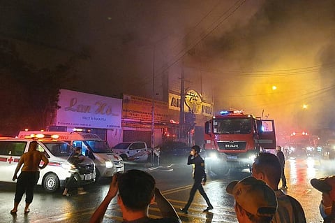 This picture taken on September 6, 2022 and released on September 7 by the Vietnam News Agency shows firefighters at the scene of a deadly fire that engulfed a karaoke bar in Binh Duong province, north of Ho Chi Minh City. A fire tore through a karaoke bar in Vietnam killing 12 people and leaving 11 injured, a local official said September 7. STR / Vietnam News Agency / AFP