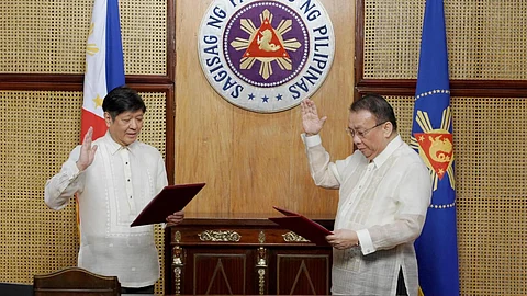 Newly appointed Executive Secretary Lucas Bersamin takes his oath before President Bongbong Marcos in Malacañang. Photo from Office of the President