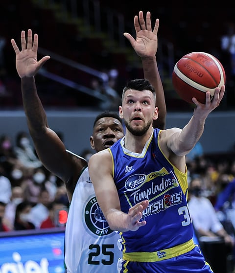 Magnolia's Nick Rakocevic goes for a layup against Terrafirma's Lester Prosper during the PBA Commissioner's Cup at the Mall of Asia Arena in Pasay, 28 September. Photo by Rio Deluvio