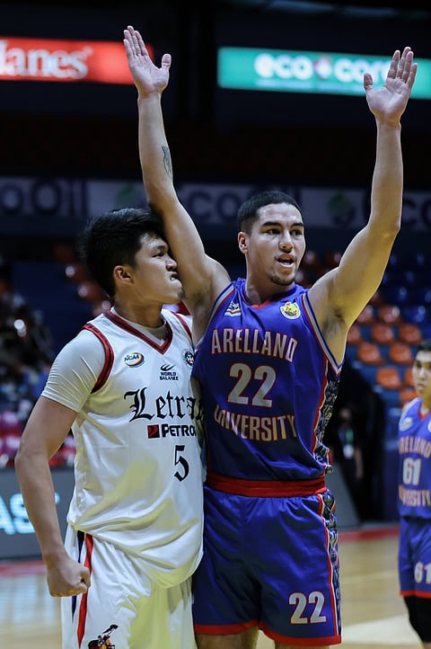 Letran's Louie Sangalang (left) reacts after a scoring against Arellano's Cade Flores during the NCAA Season 98 at the Filoil EcoOil Centre in San Juan, September 18, 2022. Photo by Rio Deluvio