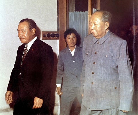 This file photo taken in September 1972 shows then-Japanese Prime Minister Kakuei Tanaka (left) walking with Chinese leader Mao Zedong (right) during his historic visit in Beijing to forge diplomatic ties, opening a new page in the two countries' troubled history. Japan and China will mark 50 years of diplomatic relations on 29 September 2022 with little public celebration, as increasing friction over territorial rivalries and military spending frays ties. (Photo by JIJI PRESS / AFP)