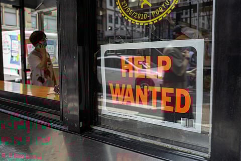 A "help wanted" sign is displayed in a window in Manhattan on 28 July 2022 in New York City. (Photo by SPENCER PLATT / GETTY IMAGES NORTH AMERICA / Getty Images via AFP)
