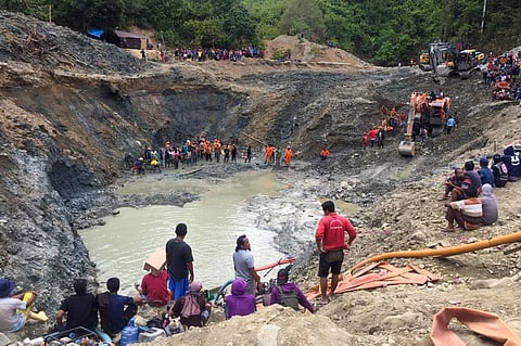 In this file photo, rescue teams conduct a search for miners buried by a landslide at an illegal gold mining operation in the village of Buranga in Parigi Moutong Regency, Central Sulawesi, on 25 February 2021. (Photo by LIA / AFP)