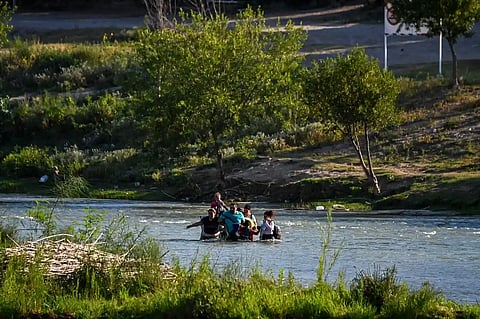 People cross the Rio Grande into Texas on 30 June. At least eight migrants drowned when a large group attempted to cross the river on Thursday. (Photo by Chandan Khanna/AFP/Getty Images)