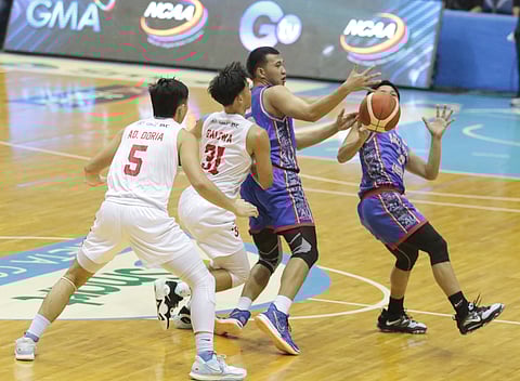 Adam Doria and Adrian Balowa of Emlio Aguinaldo College and Darrel Shane Menina and Wilmar Oftana of Arellano battle for the loose ball during the opening game of Season 98 National Collegiate Athletic Association at the Smart Araneta Coliseum. | Photograph by Joey Sanchez Mendoza for the daily tribune @tribunephl_joey