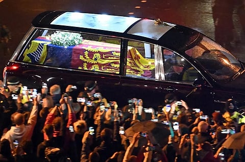 Seen from the top of the Wellington Arch, the coffin of Queen Elizabeth II is taken in the Royal Hearse to Buckingham Palace in London, England, on 13 September 2022. (Photo by MARCO BERTORELLO / POOL / AFP)