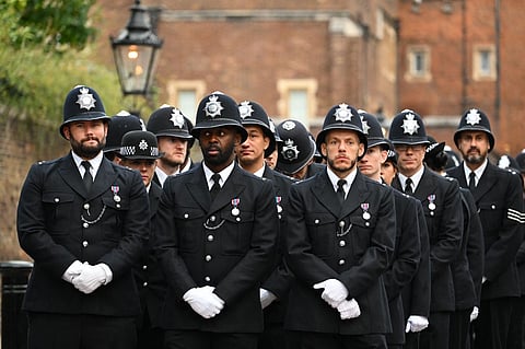 Police officers prepare in London on 19 September 2022, ahead of the State Funeral Service of Britain's Queen Elizabeth II. The country's longest-serving monarch, who died aged 96 after 70 years on the throne, was honored with a state funeral on Monday morning at Westminster Abbey. (Photo by SEBASTIEN BOZON / AFP)