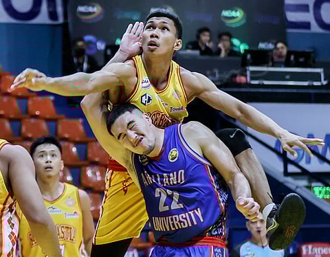 RHINWIL Yambing of San Sebastian College lands on Cade Flores of Arellano University during their NCAA Season 98 men’s basketball tournament game yesterday at the Filoil EcoOil Centre in San Juan. | Photograph by Rio Deluvio for the Daily Tribune
