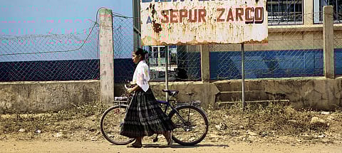 This indigenous woman in Guatemala walks her bicycle on her way to work. | Photograph courtesy of UN Women