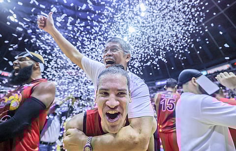 San Miguel’s Marcio Lassiter gives head coach Leo Austria a piggy-back ride after the Beermen overwhelmed TNT Tropang Giga, 119-97, in Game 7 of the PBA Philippine Cup finals at the Smart Araneta Coliseum. | photograph by Rio Deluvio for the daily tribune @tribunephl_rio