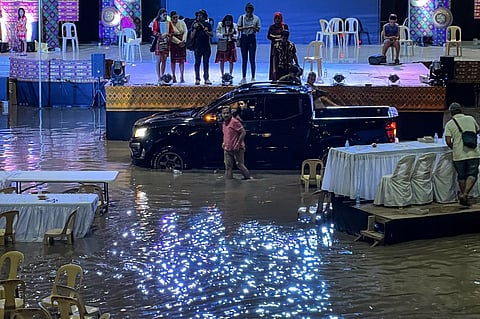Residents trapped inside a gym in the town of Upi in Maguindanao province, southern Philippines, which was flooded after heavy rains brought about by tropical storm Nalgae. - Landslides and flooding killed 13 people as heavy rain from approaching tropical storm Nalgae lashed the southern Philippines on October 28, a disaster official said. Photo by Handout / REMAR PABLO / AFP