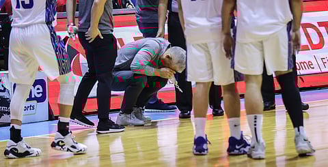 TNT head coach Chot Reyes crouched in disappointment as the Tropang Giga took a beating from Magnolia in the PBA Commissioner's Cup at the Smart Araneta Coliseum. Photo by Rio Deluvio