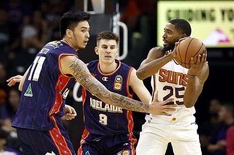 Kai Sotto #11 of the Adelaide 36ers defends Mikal Bridges #25 of the Phoenix Suns during the first half at Footprint Center on October 02, 2022 in Phoenix, Arizona. Photo by Chris Coduto / GETTY IMAGES NORTH AMERICA / Getty Images via AFP