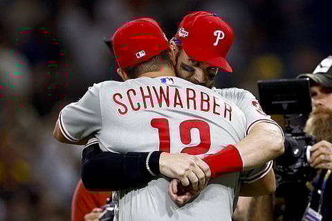 Kyle Schwarber of the Philadelphia Phillies celebrates with Bryce Harper after defeating the San Diego Padres 2-0 in game one of the National League Championship Series at PETCO Park on 18 October 18 in San Diego, California. Photo by Ronald Martinez/Getty Images/AFP