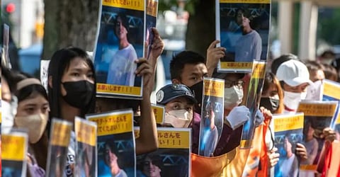 A group of activists hold placards of Japanese citizen Toru Kubota, who is detained in Myanmar, during a rally in front of the Ministry of Foreign Affairs in Tokyo on 31 July 2022. (File Photo: AFP/Philip Fong)