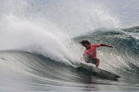 John Mark Tokong rides through gigantic waves of Could 9 in General Luna in Siargao. He emerged victorious against Japan’s Yuji Nishi in the bout. Photo by Alvin Kasiban