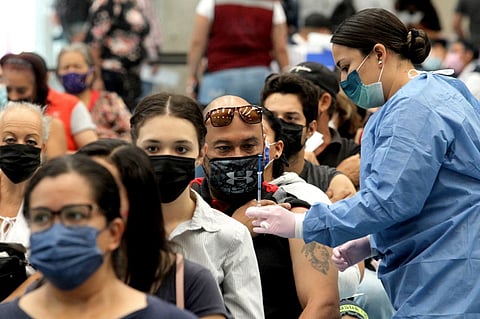 In this file photo, a man receives a booster dose of the AstraZeneca COVID-19 vaccine at a vaccination center for people over 18 years old, in Guadalajara, Jalisco state, Mexico, on 6 April 2022. (Photo by ULISES RUIZ / AFP)