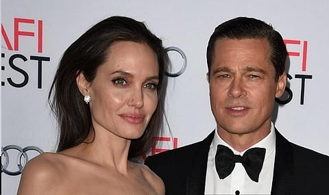 In this file photo taken on 5 November 2015, writer-director-producer-actress Angelina Jolie Pitt and actor-producer Brad Pitt arrive for the opening night gala premiere of Universal Pictures' "By the Sea". Pitt allegedly hit one of his children in the face and choked another during a fight with Jolie on a private plane, according to court papers filed 4 October 2022 in the United States by his ex-wife. (Photo by MARK RALSTON / AFP)