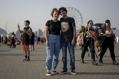 Bruna Ramiro Braz Araujo (left), 19, and Mateus de Medeiros Nunes, 18, at the Rock in Rio music festival in Rio de Janeiro, Brazil, on 9 September 2022. Surveys indicate that voters between the ages of 16 and 24 will vote massively for the leftist Luiz Inácio Lula da Silva: 54 percent compared to 24 percent for Bolsonaro, according to the latest Datafolha Institute survey. (Photo by MAURO PIMENTEL / AFP)