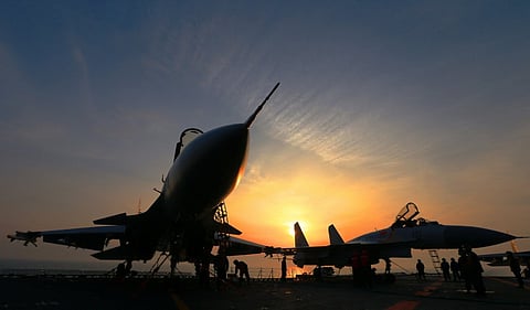 This file photo taken on 24 April 2018 shows J15 fighter jets on China's operational aircraft carrier, the Liaoning, during a drill at sea. During Xi Jinping's decade-long rule, China has built the world's largest navy, revamped the world's largest standing army, and amassed a nuclear and ballistic arsenal to trouble any foe. (Photo by AFP)
