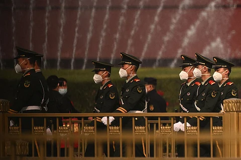 Security personnel march in front of Tiananmen Gate ahead of China's 20th Communist Party Congress in Beijing on 13 October 2022. (Photo by NOEL CELIS / AFP)
