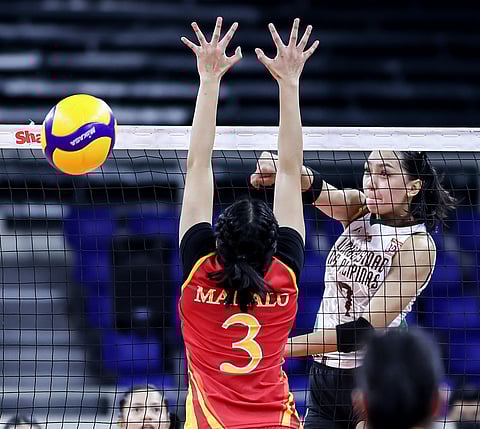 Dannica Celis of University of the Philippines breaks the defense of Therese Manalo of Mapua in their Shakey’s Super League Collegiate Conference match at the Rizal Memorial Coliseum. UP won, 25-19, 25-21, 25-11. | Photograph by Rio deluvio for the daily tribune @tribunephl_rio