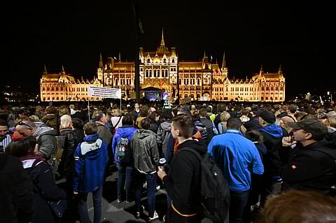 In this file photo taken on 5 October 2022, teachers, students, and parents protest in front of the parliament building against the Hungarian government's education policy and demand better working conditions for teachers. (Photo by ATTILA KISBENEDEK / AFP)