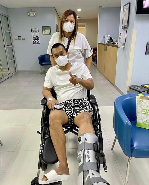 Chito Victolero gets wheeled out of the hospital by wife, Lore Jean, after undergoing operation to repair his torn Achilles tendon. Photo courtesy of Chito Victolero