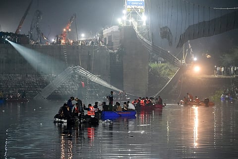 More than 130 people were killed in India after a colonial-era pedestrian bridge collapsed, sending scores of people tumbling into the river below. (Photo by SAM PANTHAKY / AFP)