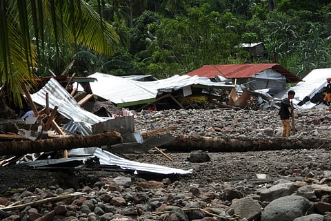 About 60 houses were buried, while a few others made of lighter materials were swept down toward the road below, said Lieutenant-Colonel Dennis Almorato, spokesman for an army division tasked with helping rescue efforts. (Photo by FERDH CABRERA / AFP)