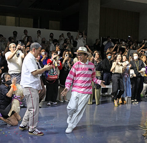BENCH founder Ben Chan (left) applauds designer Lesley Mobo after the latter's Masaganang Bukid fashion presentation.