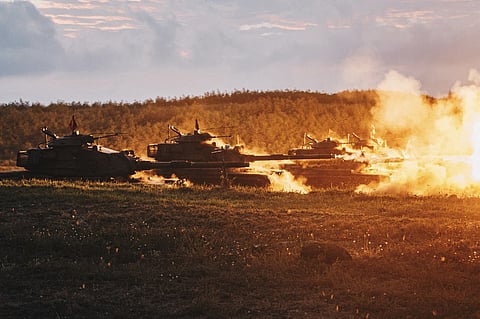 This Taiwan Ministry of National Defense handout picture taken and released on 24 August 2022 shows US-made M60-A3 tanks firing during a drill at Penghu islands. (Photo by Handout / Taiwan's Ministry of National Defense / AFP)