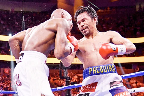 Manny Pacquiao (R) of the Philippines fights against Yordenis Ugas of Cuba during the WBA Welterweight Championship boxing match at T-Mobile Arena in Las Vegas, Nevada on August 21, 2021. - Cuba's Yordenis Ugas upset Manny Pacquiao to retain his WBA welterweight crown on Saturday, winning by unanimous decision after a bruising 12-round battle at the T-Mobile Arena. (Photo by Patrick T. FALLON / AFP)