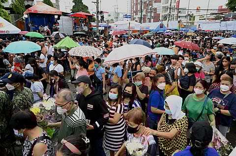 People arrive to mark All Saints Day at Manila North Cemetery in Manila on November 1, 2022. Photo by JAM STA ROSA / AFP