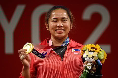 Tokyo Olympic gold medalist Hidilyn Diaz will be among the 21 candidates who will vie for the International Weightlifting Federation position. Photo by Vincenzo PINTO / AFP