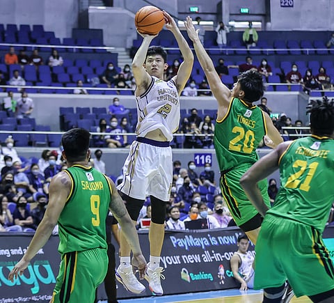 NU's Patrick Yu scores against FEU's Xyrus Torres during their UAAP Season 85 men's basketball match at the Smart Araneta Coliseum. (Photo by Rio Deluvio)