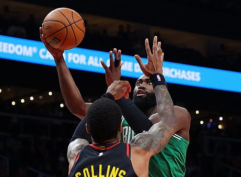 Jaylen Brown of the Boston Celtics drives against John Collins of the Atlanta Hawks during the first half at State Farm Arena on 16 November in Atlanta, Georgia. Photo by Kevin C. Cox / GETTY IMAGES NORTH AMERICA / Getty Images via AFP