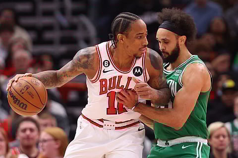 DeMar DeRozan of the Chicago Bulls drives to the basket against Derrick White of the Boston Celtics during the first half at United Center on November 21, 2022 in Chicago, Illinois. Photo by Michael Reaves / GETTY IMAGES NORTH AMERICA / Getty Images via AFP