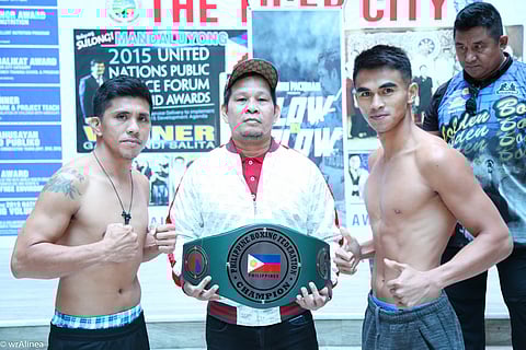 Criztian Pitt Laurente (right) strikes a pose with opponent JR Magboo after the official weighin for their vacant Philippine Boxing Federation super-featherweight title set Sunday night at the Mandaluyong City College. Two-time world champion Gerry Peñalosa (center) has been tasked to handle the fights. | PHOTOGRAPH COURTESY OF Blow-by-Blow