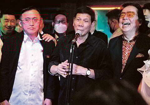 President Duterte flanked by Senator Go and RJ Jacinto.